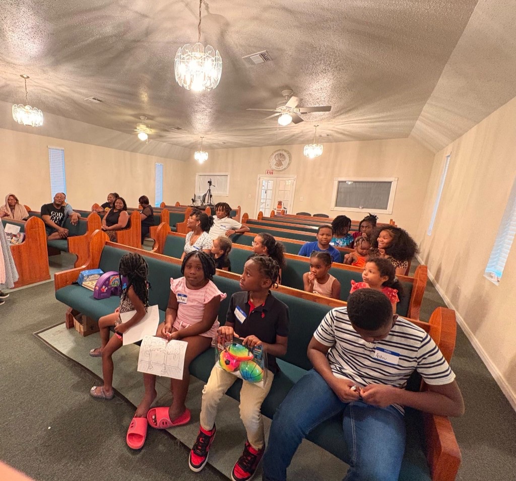 Kids and families gathered in the sanctuary at Victorious Overcomers
